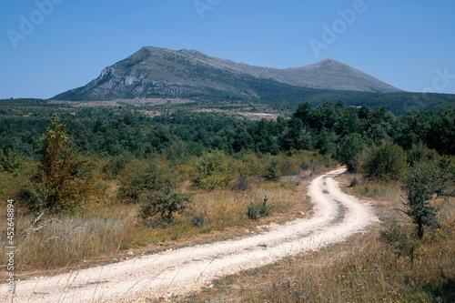 Serbia - A dirt road leading to the Mountain Rtanj photo