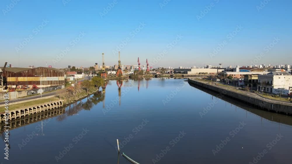 Aerial dolly in shot capturing the revitalize waterways from Matanza river with industrial port cranes along the riverside in Buenos Aires. Aerial dolly in shot capturing the revitalize waterways from Matanza river with industrial port cranes along the riverside in Buenos Aires.