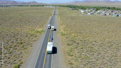 Aerial: Vehicles Moving On Road Amidst Semi Arid Landscape On Sunny Day - Lake Tahoe, California