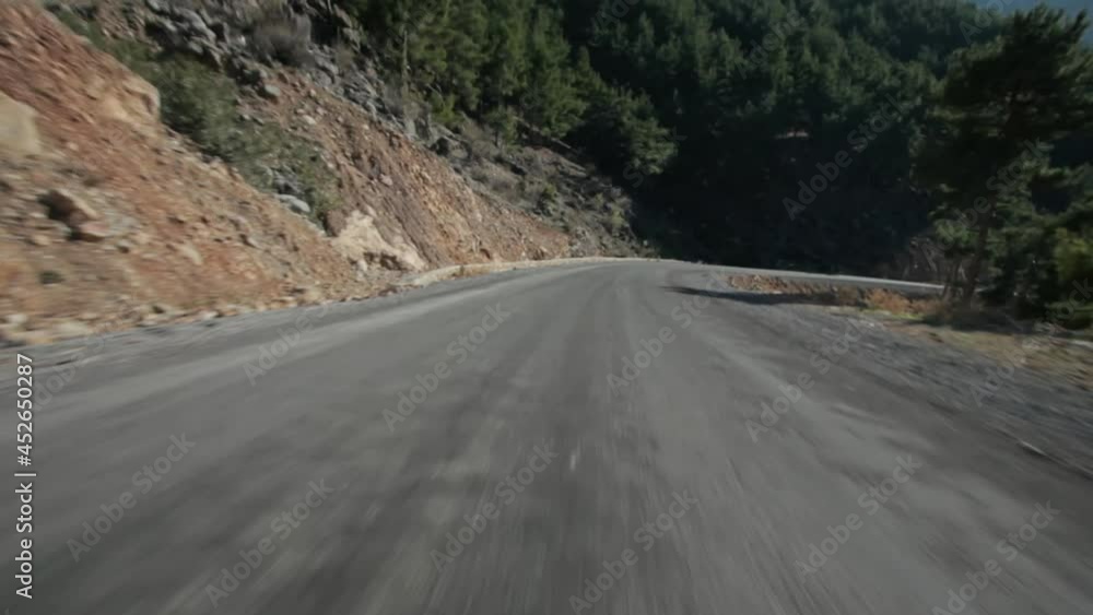 Car Mounted view of Driving on Asphalt Road between Mountains and Forest Car Mounted view of Driving on Asphalt Road between Mountains and Forest
