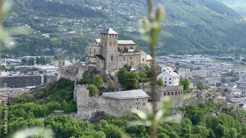 The Valeria Castle next to the Tourbillon Castle in Sion, Canton Valais in Switzerland. The castle stands on a hill and the city of Sion can be seen in the background. photo