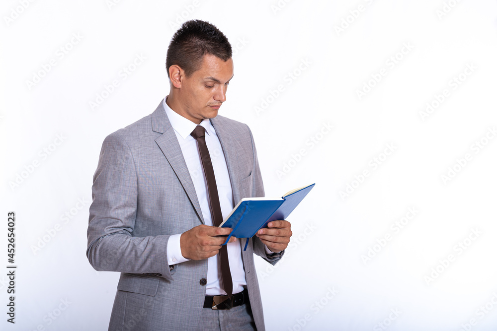 a young handsome businessman in a suit with a notebook a young handsome businessman in a suit with a notebook