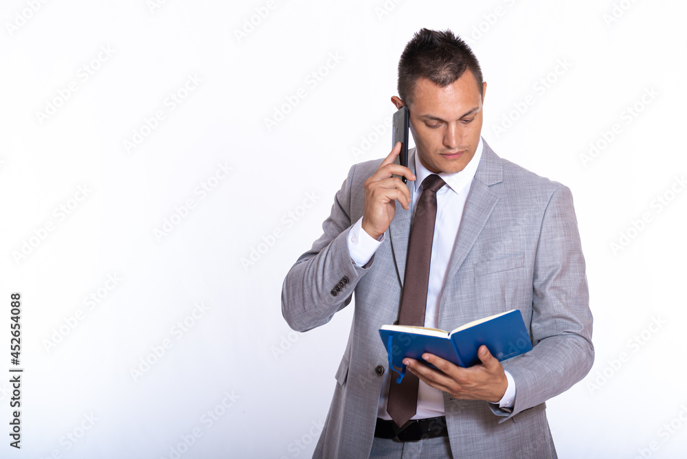 a young handsome businessman in a suit with a notebook a young handsome businessman in a suit with a notebook