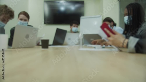 People are working together in the office room and looking through documents
