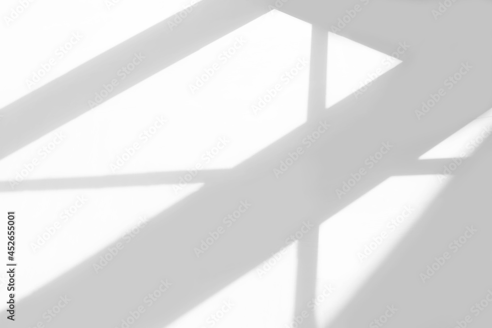Fototapeta premium Gray window shadow and light blur abstract background on white wall, shadow overlay effect