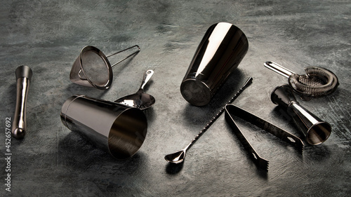 Cocktail bar equipment on dark background.