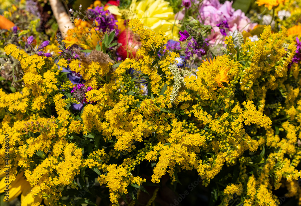 Obraz premium Traditional bouquet of flowers, herbs and fruits that are the symbol of summer
