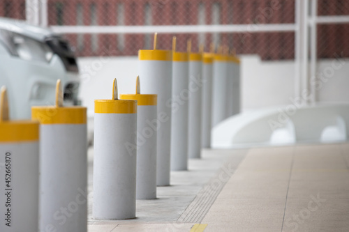 steel bollards on footpath near parking lot.