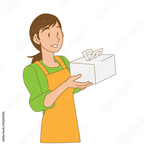 ケーキの箱を抱えて微笑む女性