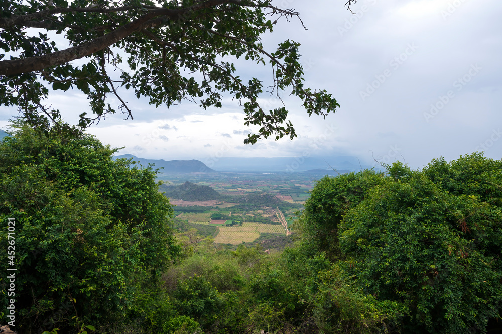 Obraz premium South indian mountain surrounded by the agriculture land close up view. close up view of the mountain rocks...