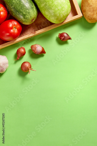Healthy Vegetable with pastel concept. Tomato, squash, bottle gourd on brighten green background. Top view. Clean and Fresh Food.