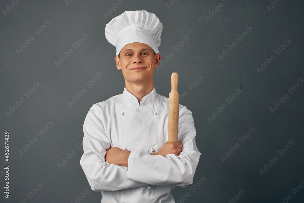 chef holding a rolling pin in his hands cooking professionals chef holding a rolling pin in his hands cooking professionals