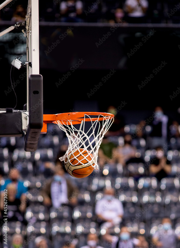 scoring during a basketball game ball in hoop