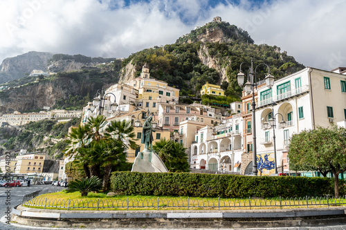 Amalfi, Campania, Italy, February 2020: Beautiful View of Amalfi from Flavio Gioia square, with fountain and statue. Amalfi coast