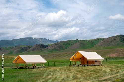 Glamping tents in mountain plateau. Outdoor recreation, freedom journey concept. Nature leisure activity. Glamping concept. Summer camp.