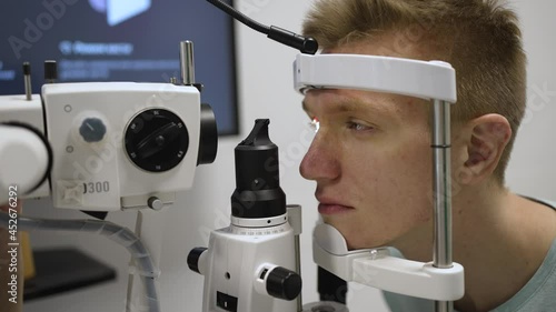Laser vision correction. Doctor checks patient eyes using autoref keratometer photo