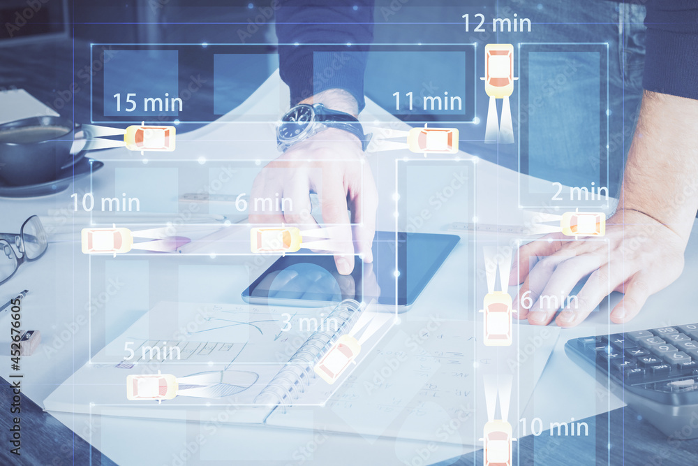Double exposure of man's hands holding and using a digital device and automobile theme hologram drawing. Technology concept. Double exposure of man's hands holding and using a digital device and automobile theme hologram drawing. Technology concept.