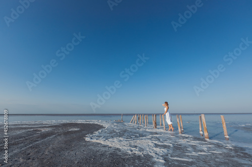 A girl in a white dress on the salt lake Sasyk Sivash Crimea