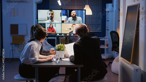 Obraz na plátně Multi ethnic businesspeople brainstorming company ideas during online videocall conference meeting discussing with remote teamwork