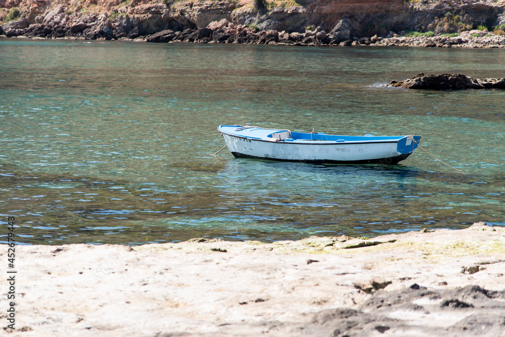 Small old boat anchored near the beach Small old boat anchored near the beach