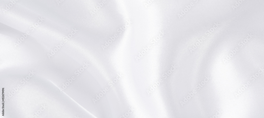 abstract smooth elegant white fabric silk texture soft background,flowing satin waves