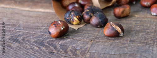 roasted chestnuts  spilled on wooden table