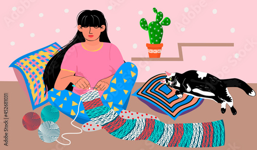 Crochet Day illustration in flat cartoon style.The girl is crocheting a striped scarf  in a cozy environment with a cat, cactus and pillows.A young woman sits and knits. Crochet concept.