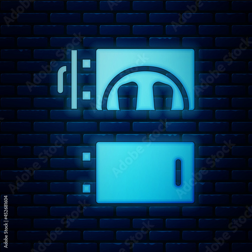 Glowing neon Crematorium icon isolated on brick wall background. Vector