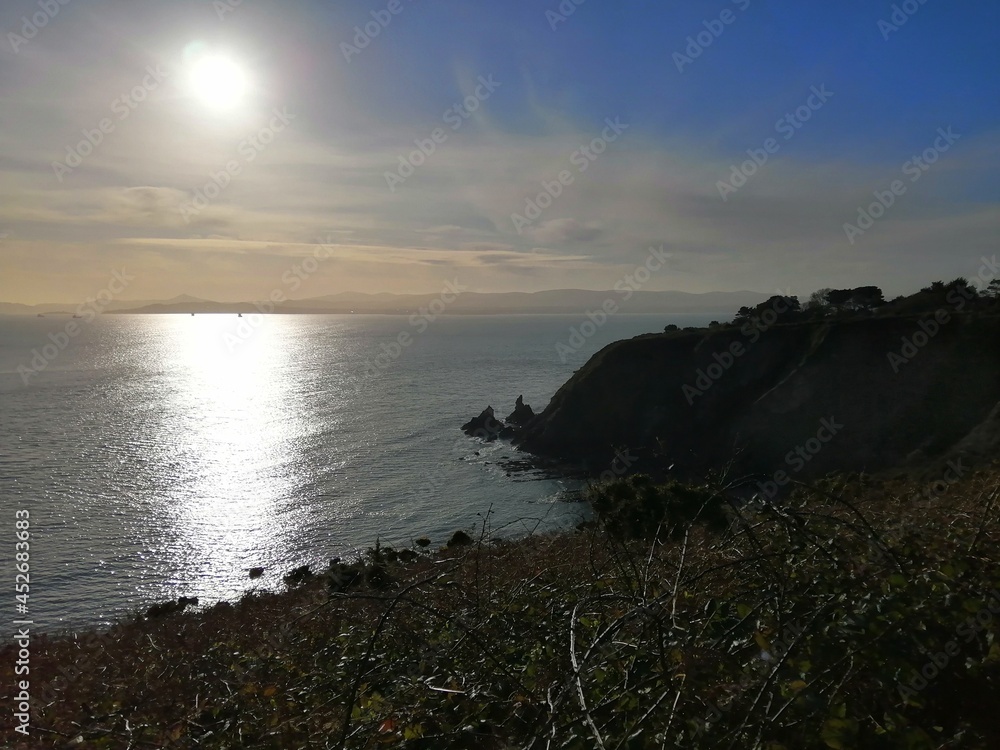 Howth Cliff Walk with mid morning sun overlooking the ocean in Dublin take 1