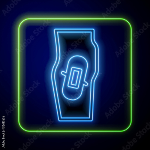 Glowing neon Plaster on leg icon isolated on blue background. Vector