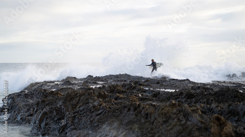 Surfer on the rocks