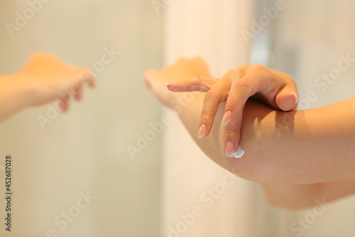 Wallpaper Mural Woman hands applying moisturizer cream on elbow Torontodigital.ca