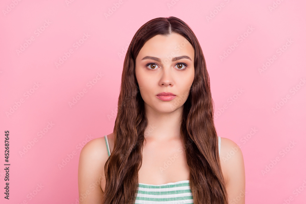 Photo of calm focused charming pretty cute lady look camera wear striped top isolated pink color background Photo of calm focused charming pretty cute lady look camera wear striped top isolated pink color background