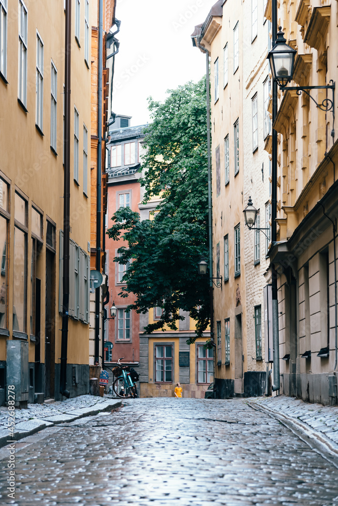 View of empty narrow cobblestoned street in Gamla Stan, Stockholm, after rain, the Old Town is one of the largest and best preserved medieval city centers in Europe