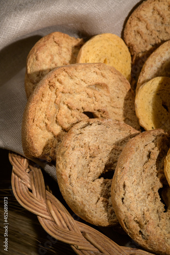 Basket with friselle. Classical apulian dried bread called freselle. Healthy vegetarian food, close up, selective focus photo