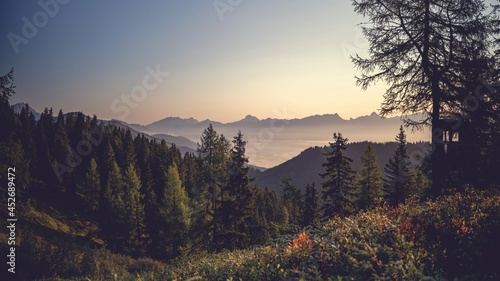 a misty morning in the valley and beautiful sunrise on the mountains with view of the alps