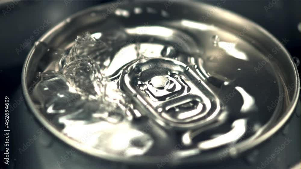 Super slow motion on a tin with beer dripping drops of water with spray. Macro background.Filmed on a high-speed camera at 1000 fps. Super slow motion on a tin with beer dripping drops of water with spray. Macro background.Filmed on a high-speed camera at 1000 fps.