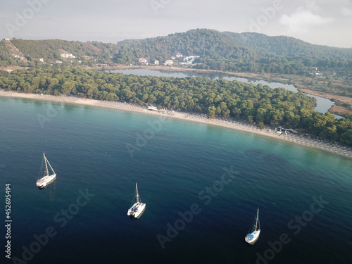 Areal view of Koukounaries beach at Skiathos and three sailboats