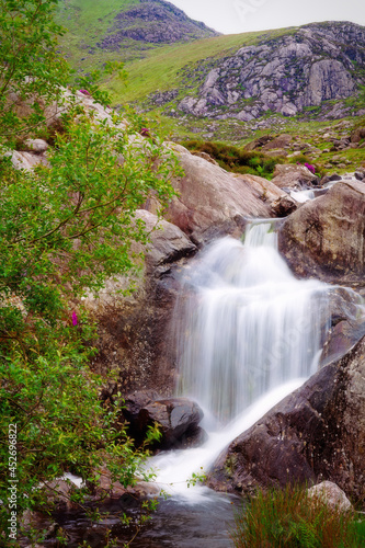 Mountain stream waterfall flows into Llyn Ogwen, North Wales