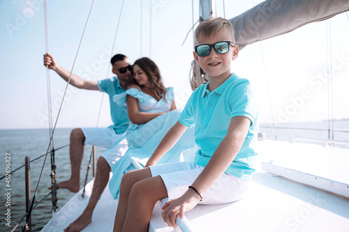 happy family mom dad son sailing on a yacht on a joint weekend. sea vacation. © Mikhaylovskiy 