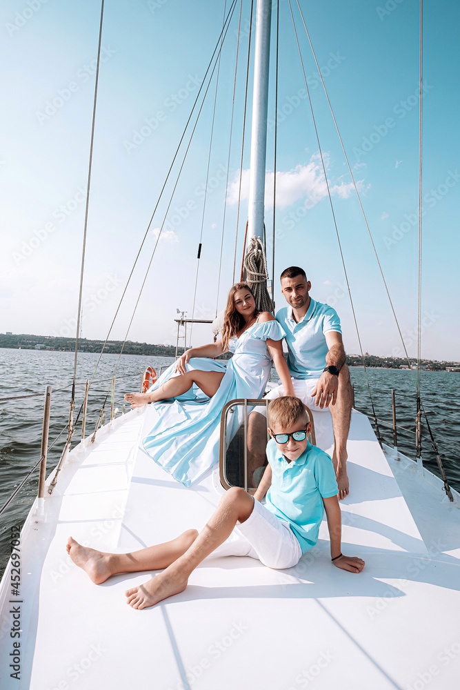 happy family mom dad son sailing on a yacht on a joint weekend. sea vacation. happy family mom dad son sailing on a yacht on a joint weekend. sea vacation.