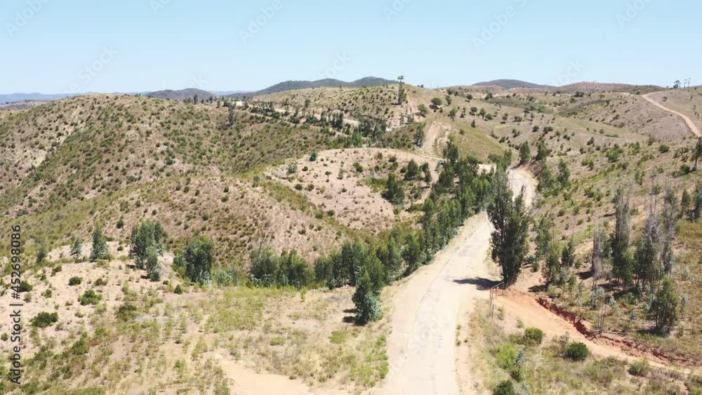 Drone flight over a reservoir that occupies an entire valley between the mountains ending at a mountain road. Drone flight over a reservoir that occupies an entire valley between the mountains ending at a mountain road.