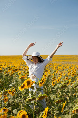 woman dancing in a field of sunflowers