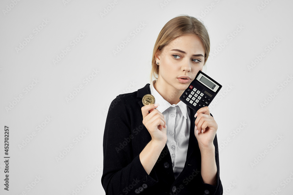 Businesswoman Bitcoin cryptocurrency in hands light background