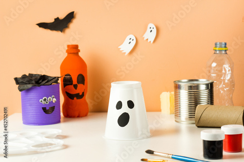 DIY for kids. Halloween home activities. Handmade toys monster, ghost and pumpkin. Reuse concept art from plastic cup photo