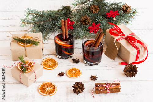 Christmas hot mulled wine with cinnamon cardamon and anise on white wooden background, New year greeting card photo