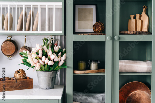 Fotografie Green vintage kitchen cupboard with glass doors
