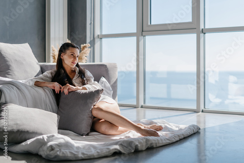 Woman relaxing on floor in morning after wake up