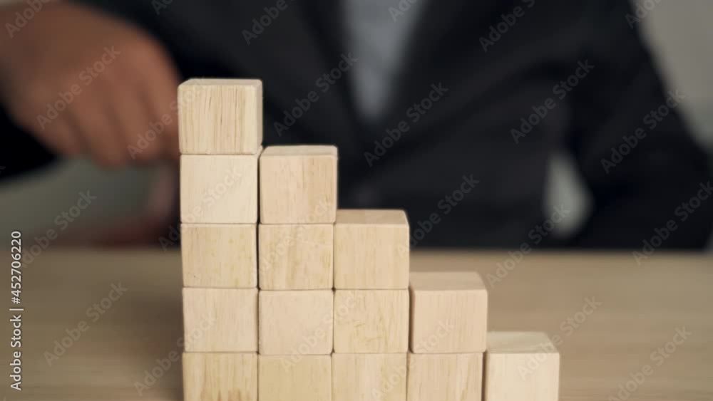 Businessmen arranging wooden cubes in a graph. growth of small business and e-commerce concept. Businessmen arranging wooden cubes in a graph. growth of small business and e-commerce concept.