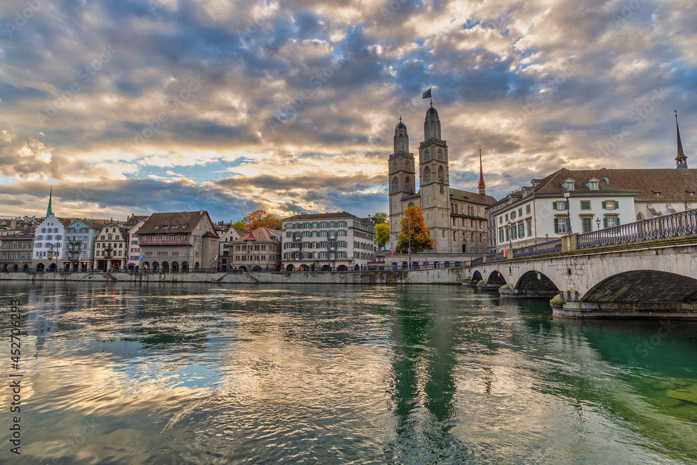 Zurich Switzerland, sunrise city skyline at Grossmunster Church and Munster Bridge with with autumn foliage season